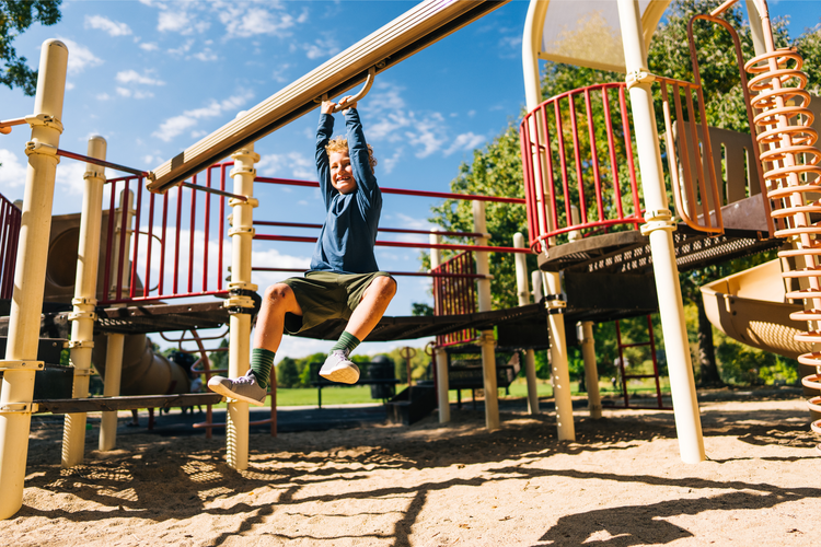 Xero shoes Canda kids. Kid playing on playground