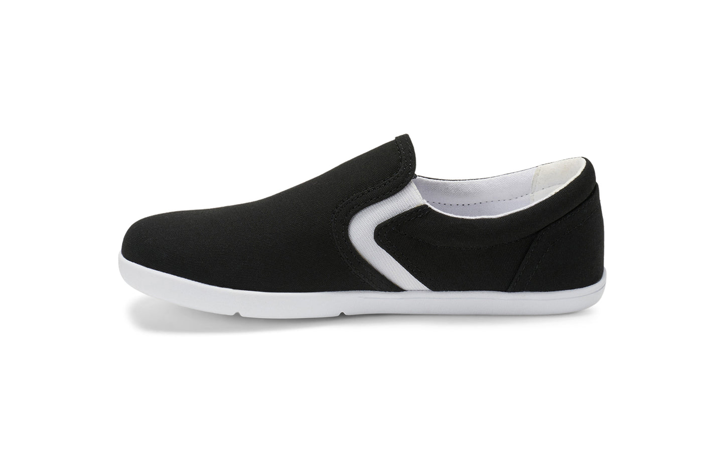Xero Kid's Barefoot Shoes sold in Ontario, Canada. These minimalist shoes have flexible soles, wide toe boxes, and zero drop. Medial side view of Xero Youth Dillon Canvas Slip-On in Black.