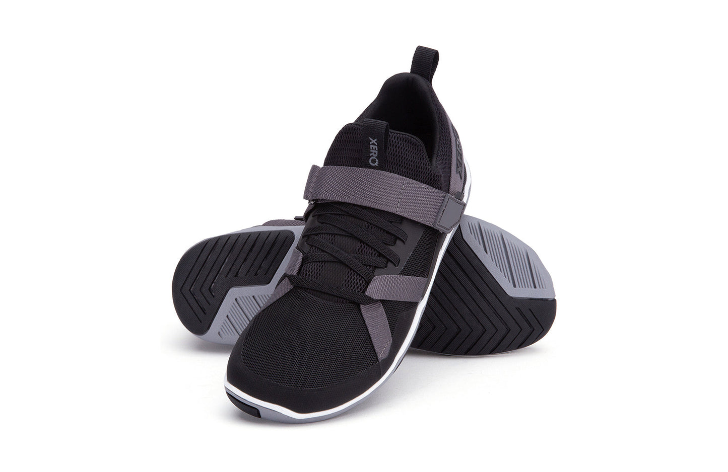 Xero Shoes Canada, specifically barefoot running shoes Canada. These minimalist shoes have flexible soles, wide toe boxes, and zero drop. Angled pair view of Xero Women's Forza Trainer in Black/Asphalt. A stable training shoe.