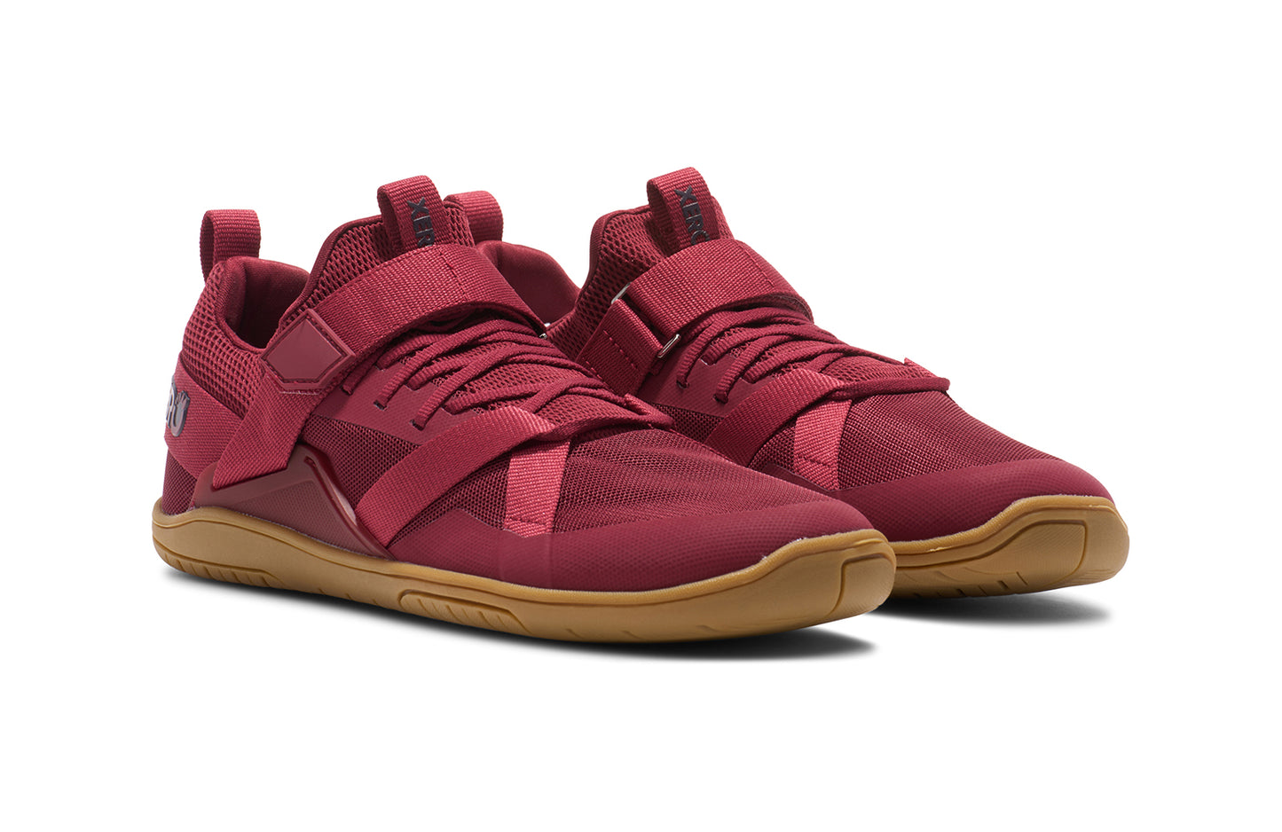 Xero Shoes Canada, specifically barefoot running shoes Canada. These minimalist shoes have flexible soles, wide toe boxes, and zero drop. Angled pair view of Xero Women's Forza Trainer in Tibetan Red/Gum. A stable training shoe.