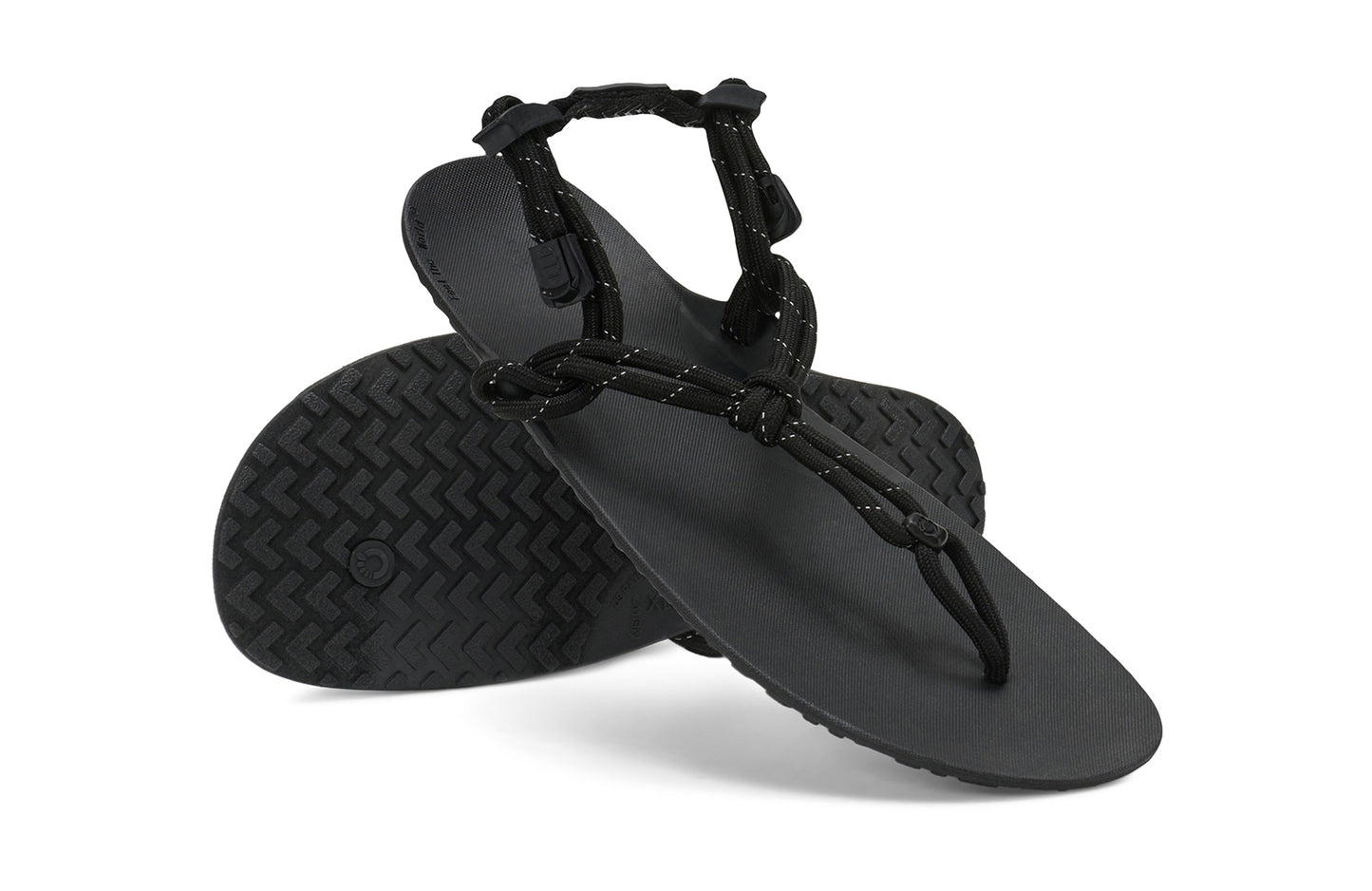 Xero Shoes Canada, specifically women’s barefoot shoes Canada. These minimalist shoes have flexible soles, wide toe boxes, and zero drop. Angled pair view of Xero Women's Genesis in Black. Lightweight, packable, travel-friendly sandal.