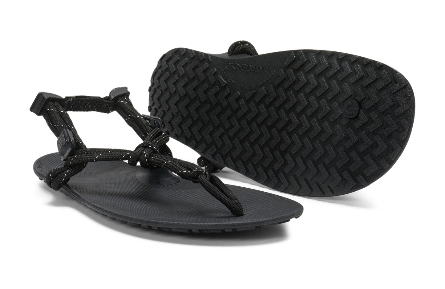 Xero Shoes Canada, specifically women’s barefoot shoes Canada. These minimalist shoes have flexible soles, wide toe boxes, and zero drop. Pair view of Xero Women's Genesis in Black. Lightweight, packable, travel-friendly sandal.
