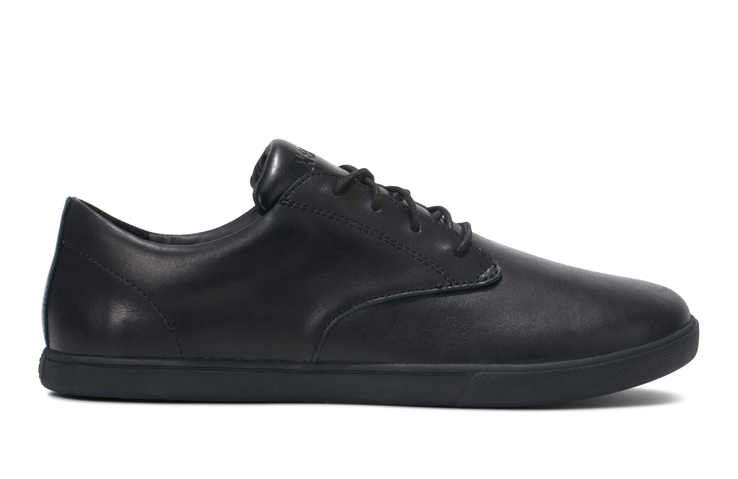 Xero Shoes Canada, specifically men’s barefoot shoes Canada. These minimalist shoes have flexible soles, wide toe boxes, and zero drop. Side view of Xero Men's Glenn Dress in Black. Dressy leather sneaker.