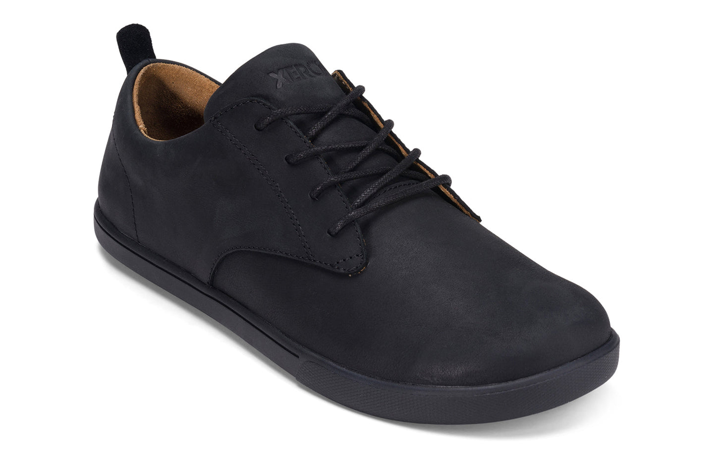 Xero Shoes Canada, specifically men’s barefoot shoes Canada. These minimalist shoes have flexible soles, wide toe boxes, and zero drop. Angled view of Xero Men's Glenn in Black. Dress casual leather shoe.