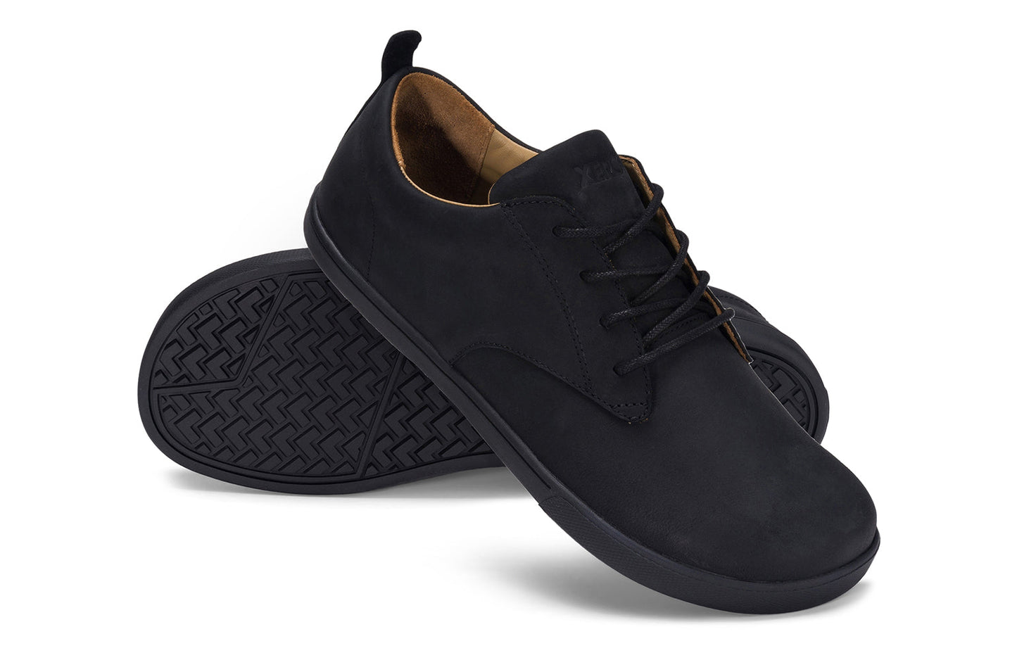 Xero Shoes Canada, specifically men’s barefoot shoes Canada. These minimalist shoes have flexible soles, wide toe boxes, and zero drop. Angled pair view of Xero Men's Glenn in Black. Dress casual leather shoe.