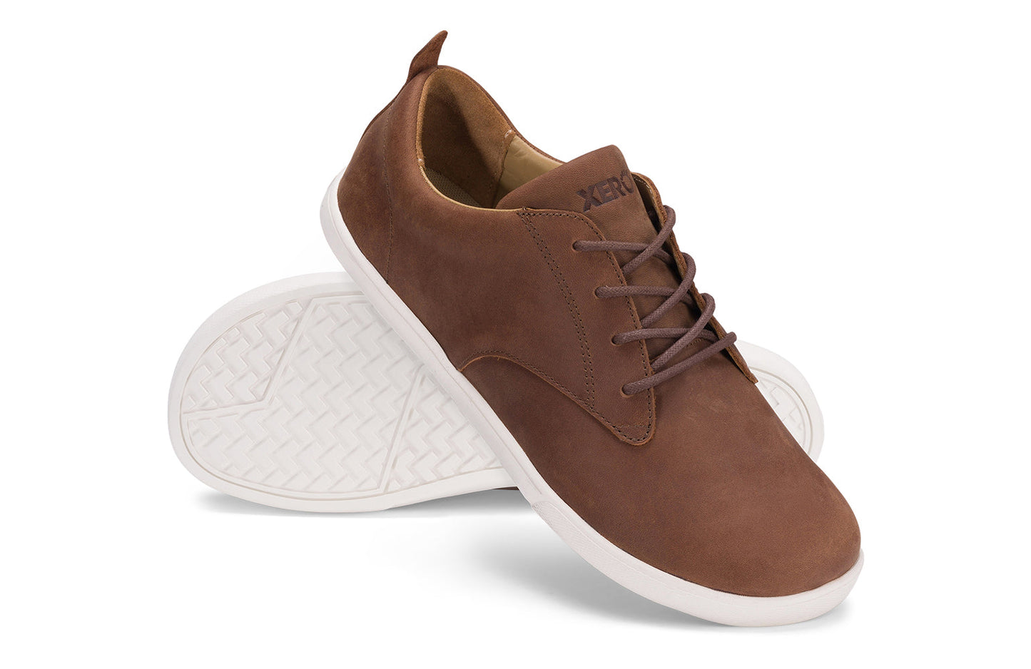 Xero Shoes Canada, specifically men’s barefoot shoes Canada. These minimalist shoes have flexible soles, wide toe boxes, and zero drop. Angled pair view of Xero Men's Glenn in Brown. Dress casual leather shoe.