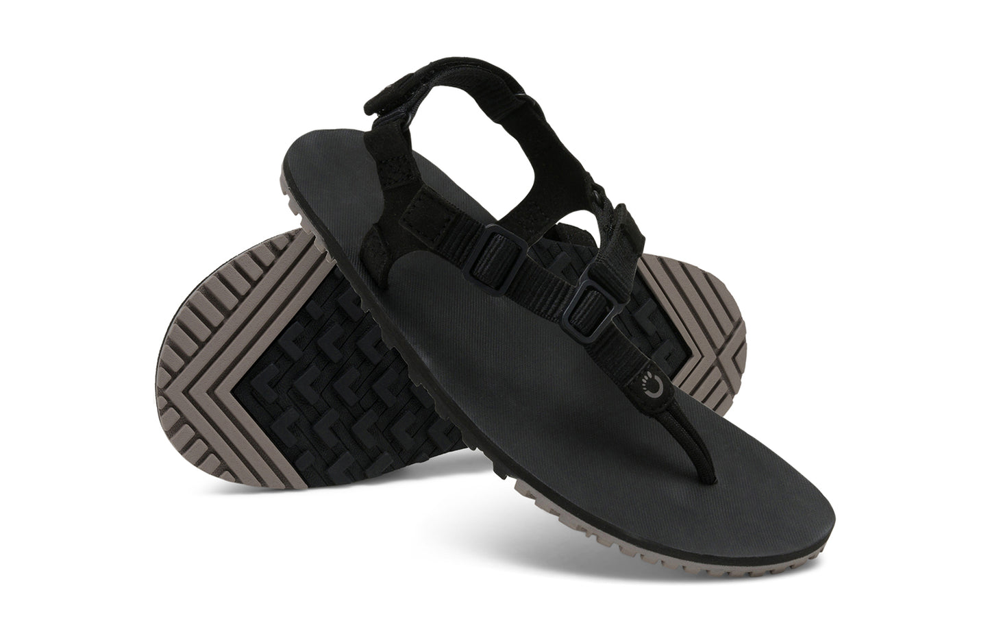 Xero Shoes Canada, specifically men’s barefoot shoes Canada. These minimalist shoes have flexible soles, wide toe boxes, and zero drop. Angled pair view of Men's H-Trail in Black. A huarache-style hiking sandal.