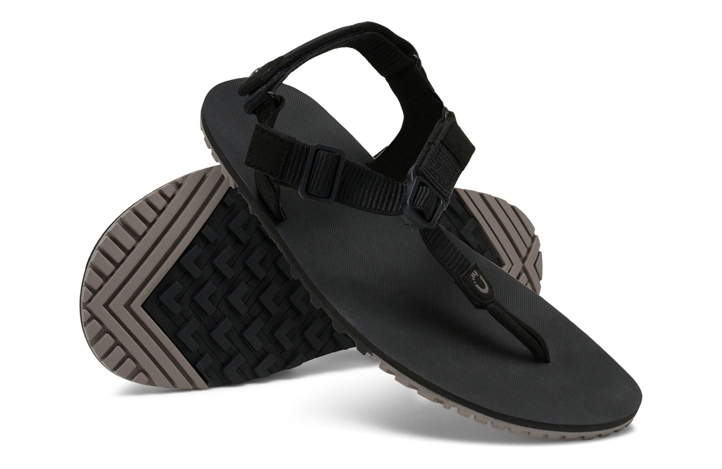 Xero Shoes Canada, specifically women’s barefoot shoes Canada. These minimalist shoes have flexible soles, wide toe boxes, and zero drop. Angled pair view of Women's H-Trail in Black. A huarache-style hiking sandal.