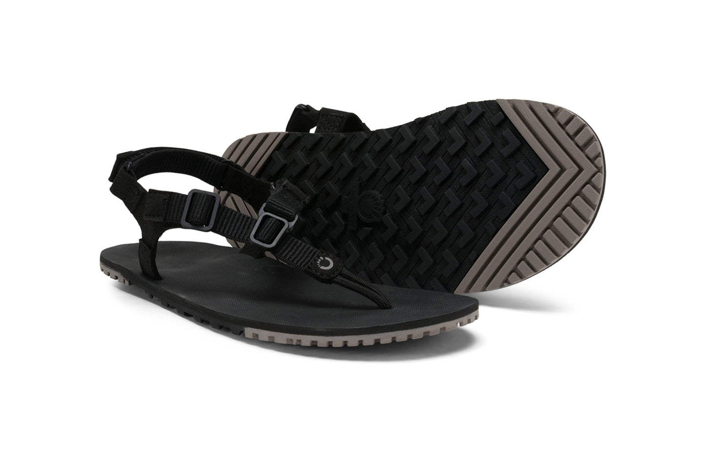 Xero Shoes Canada, specifically men’s barefoot shoes Canada. These minimalist shoes have flexible soles, wide toe boxes, and zero drop. Pair view of Men's H-Trail in Black. A huarache-style hiking sandal.