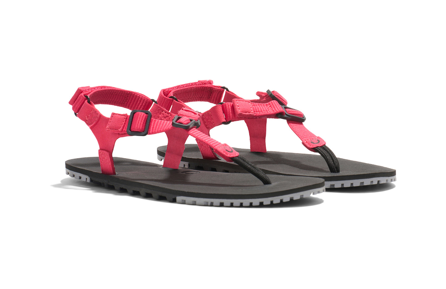 Xero Shoes Canada, specifically women’s barefoot shoes Canada. These minimalist shoes have flexible soles, wide toe boxes, and zero drop. Angled pair view of Women's H-Trail in Raspberry. A huarache-style hiking sandal.