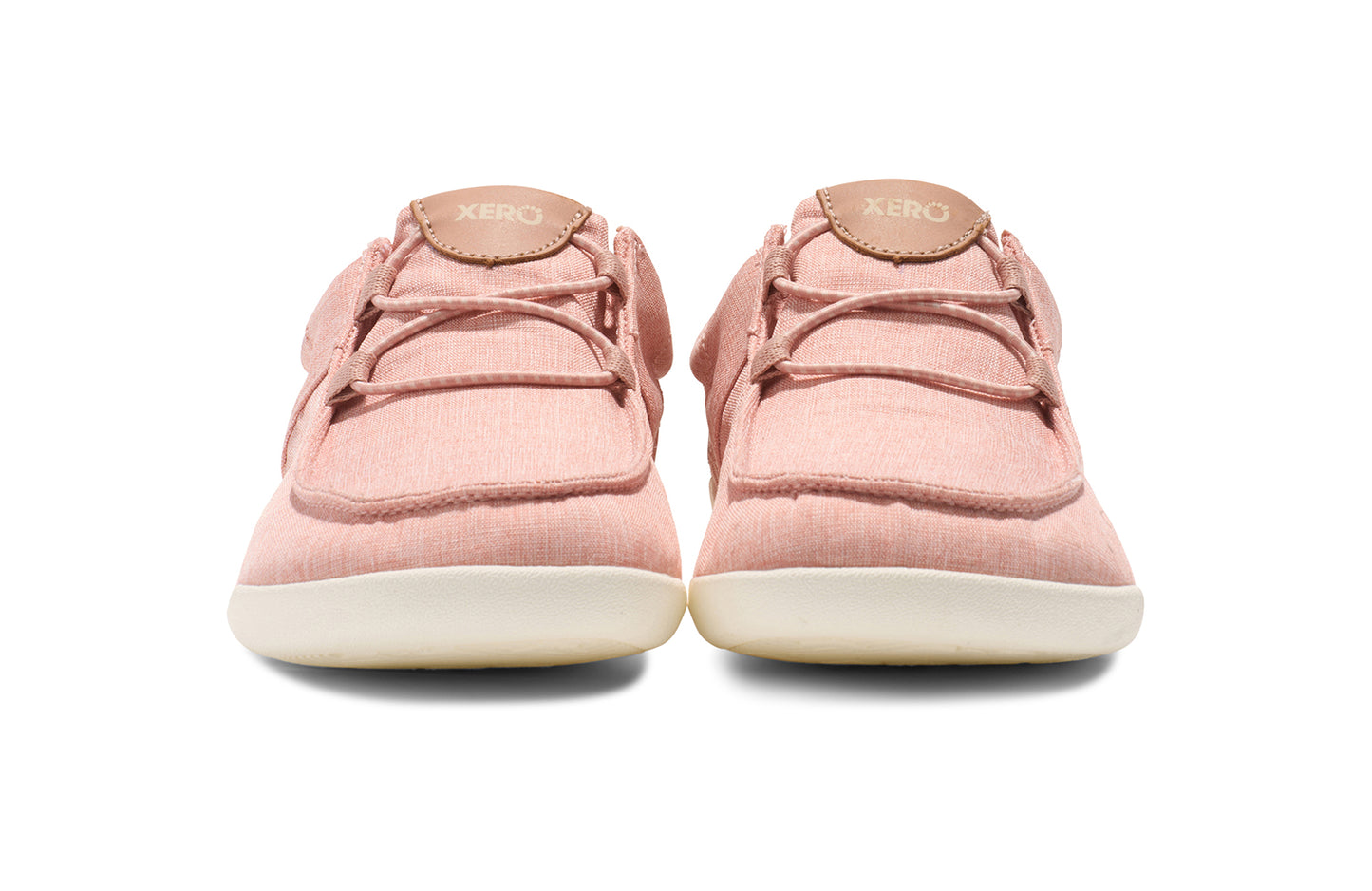 Xero Shoes Canada, specifically women’s barefoot shoes Canada. These minimalist shoes have flexible soles, wide toe boxes, and zero drop. Front view of Xero Women's Kona in Pink Sand. Moccasin inspired casual shoe.