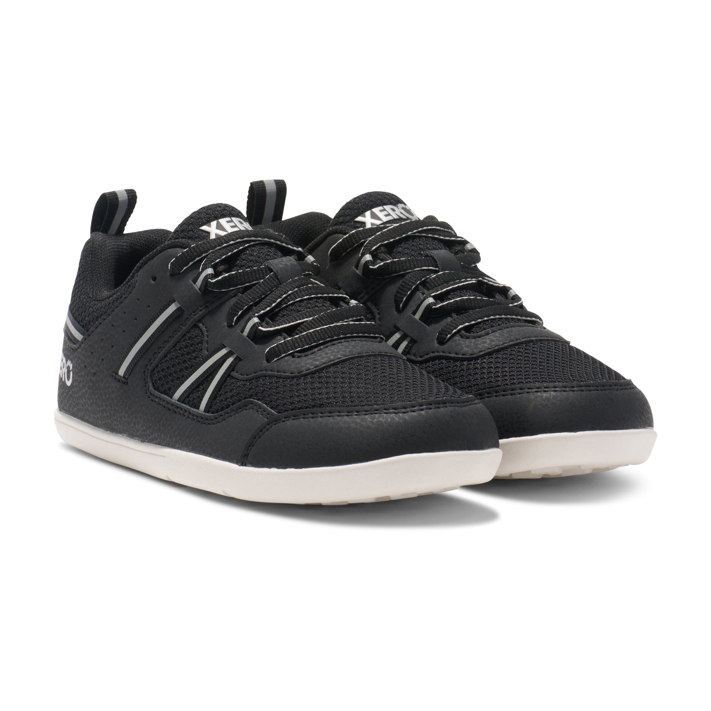 Xero Barefoot Shoes for kids sold in Ontario, Canada. These minimalist shoes have flexible soles, wide toe boxes, and zero drop. Angled view of Xero Kid's Prio in Black/White. Casual kid's sneaker.
