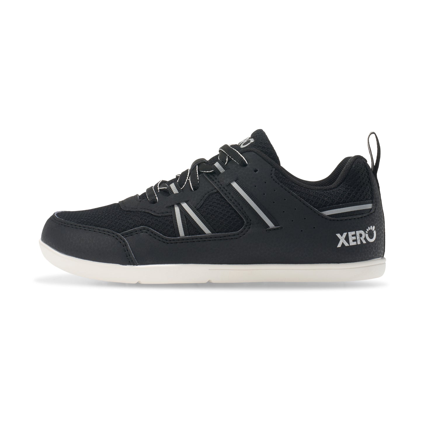Xero Barefoot Shoes for kids sold in Ontario, Canada. These minimalist shoes have flexible soles, wide toe boxes, and zero drop. Medial side view of Xero Kid's Prio in Black/White. Casual kid's sneaker.