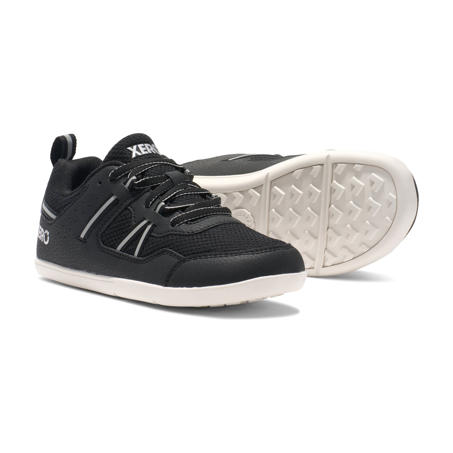 Xero Barefoot Shoes for kids sold in Ontario, Canada. These minimalist shoes have flexible soles, wide toe boxes, and zero drop. Pair view of Xero Kid's Prio in Black/White. Casual kid's sneaker.