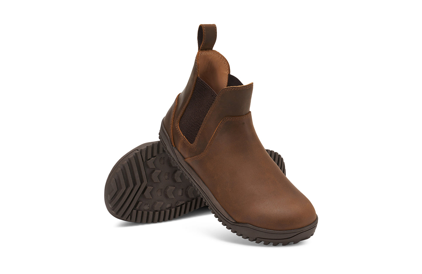 Xero Barefoot Shoes sold in Ontario, Canada. These minimalist shoes have flexible soles, wide toe boxes, and zero drop. Angled pair view of Women's Ridgeway Chelsea in Brown, a versatile boot.