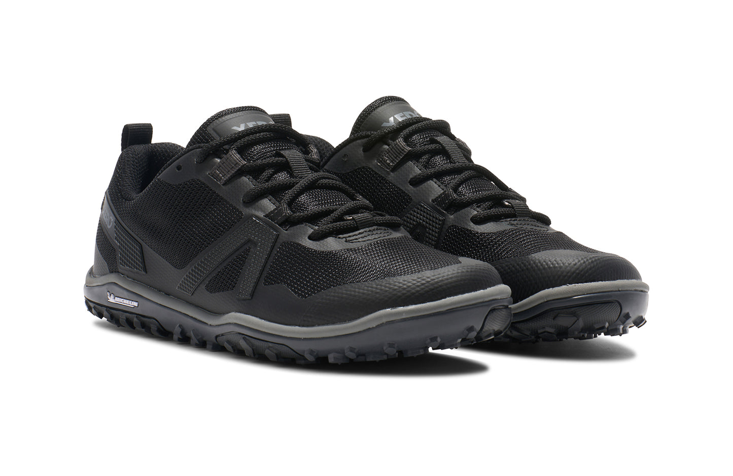 Xero Barefoot Shoes sold in Ontario, Canada. These minimalist shoes have flexible soles, wide toe boxes, and zero drop. Angled view of Xero Women's Scrambler Low EV in Black/Steel Gray, a lightweight high-performance trail runner