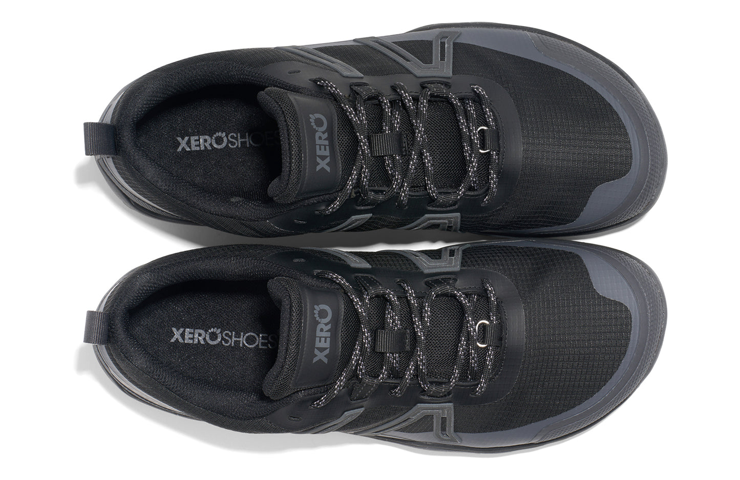 Xero Barefoot Shoes sold in Ontario, Canada. These minimalist shoes have flexible soles, wide toe boxes, and zero drop. Angled view of Xero Men's Scrambler Trail Low WP in Black/Asphalt, a sturdy hiking shoe