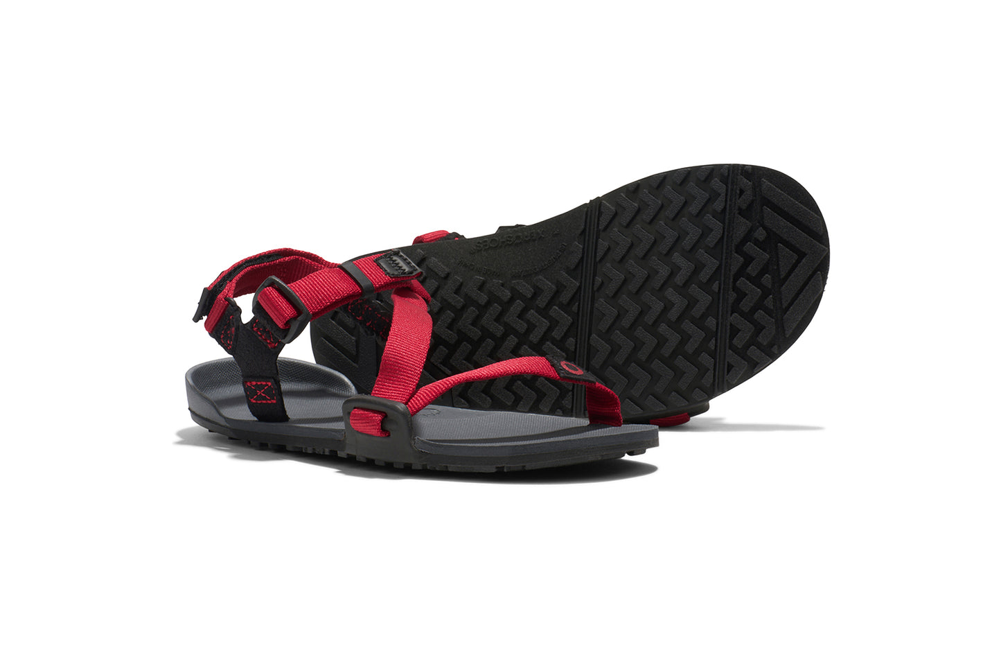 Xero Kid's Barefoot Shoes sold in Ontario, Canada. These minimalist shoes have flexible soles, wide toe boxes, and zero drop. Pair view of Xero Kid's Z-Trail in Charcoal/Red Pepper, a lightweight packable sport sandal.
