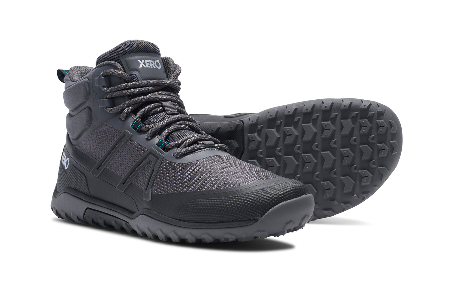 Xero Barefoot Shoes sold in Ontario, Canada. These minimalist shoes have flexible soles, wide toe boxes, and zero drop. Side and Sole view of Xero Women's Scambler Trail Mid in Asphalt/Black, a lightweight hiking boot
