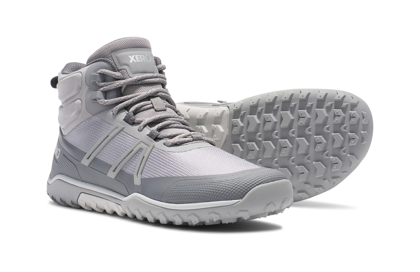 Xero Barefoot Shoes sold in Ontario, Canada. These minimalist shoes have flexible soles, wide toe boxes, and zero drop. Side and sole view of Xero Women's Scambler Trail Mid in Alloy/Steel Gray, a lightweight hiking boot
