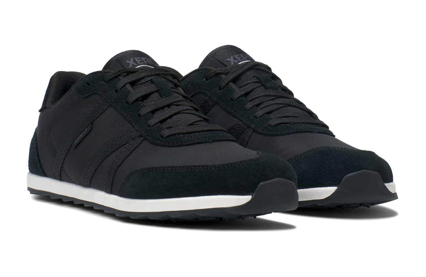 Xero Barefoot Shoes sold in Ontario, Canada. These minimalist shoes have flexible soles, wide toe boxes, and zero drop. Side view of Xero Men's Wynn in Black/White, a casual sneaker