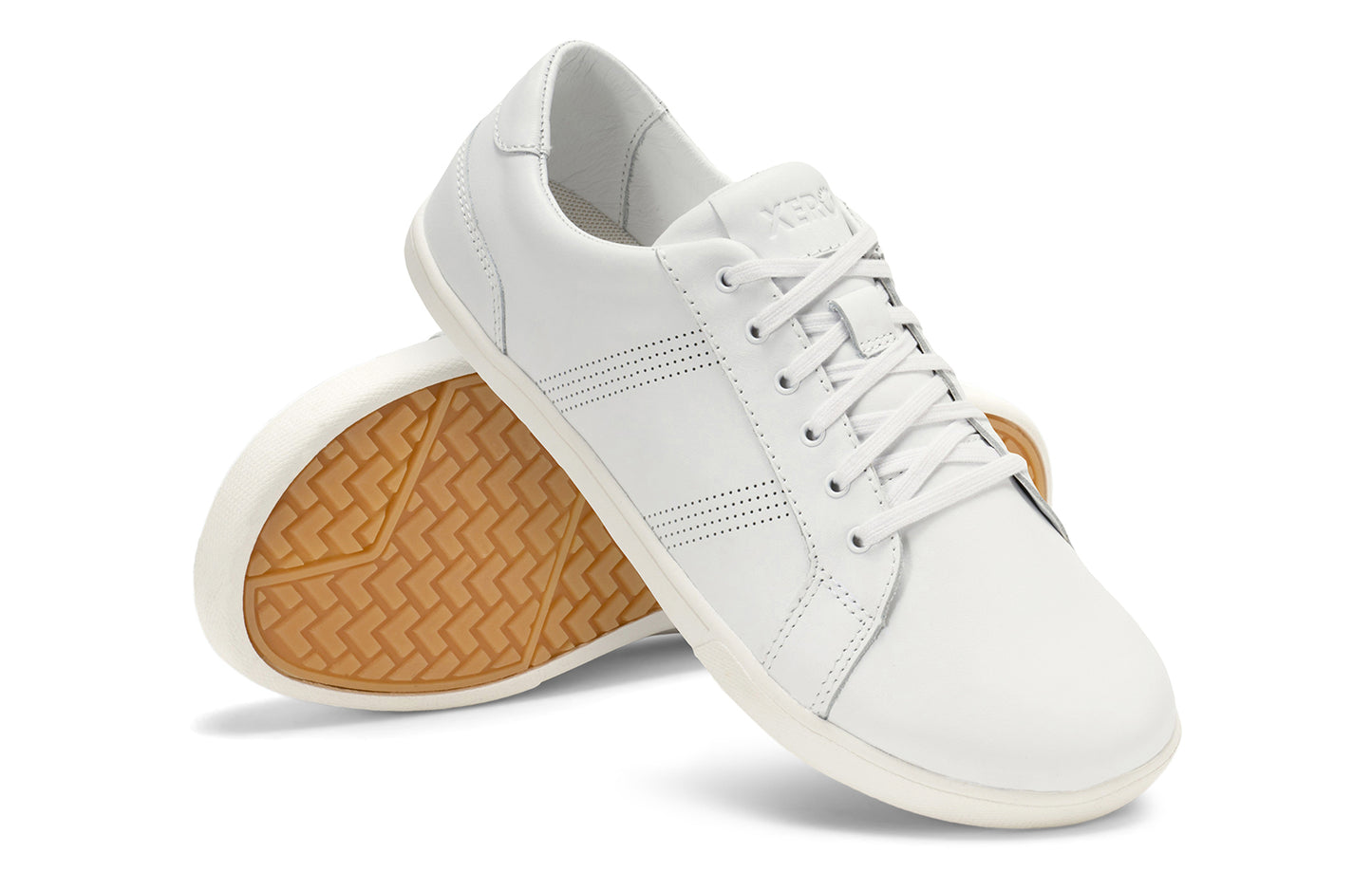 Xero Shoes Canada, specifically men’s barefoot shoes Canada. These minimalist shoes have flexible soles, wide toe boxes, and zero drop. Angled pair view of Men's Dillon Leather in White. A classic leather sneaker.