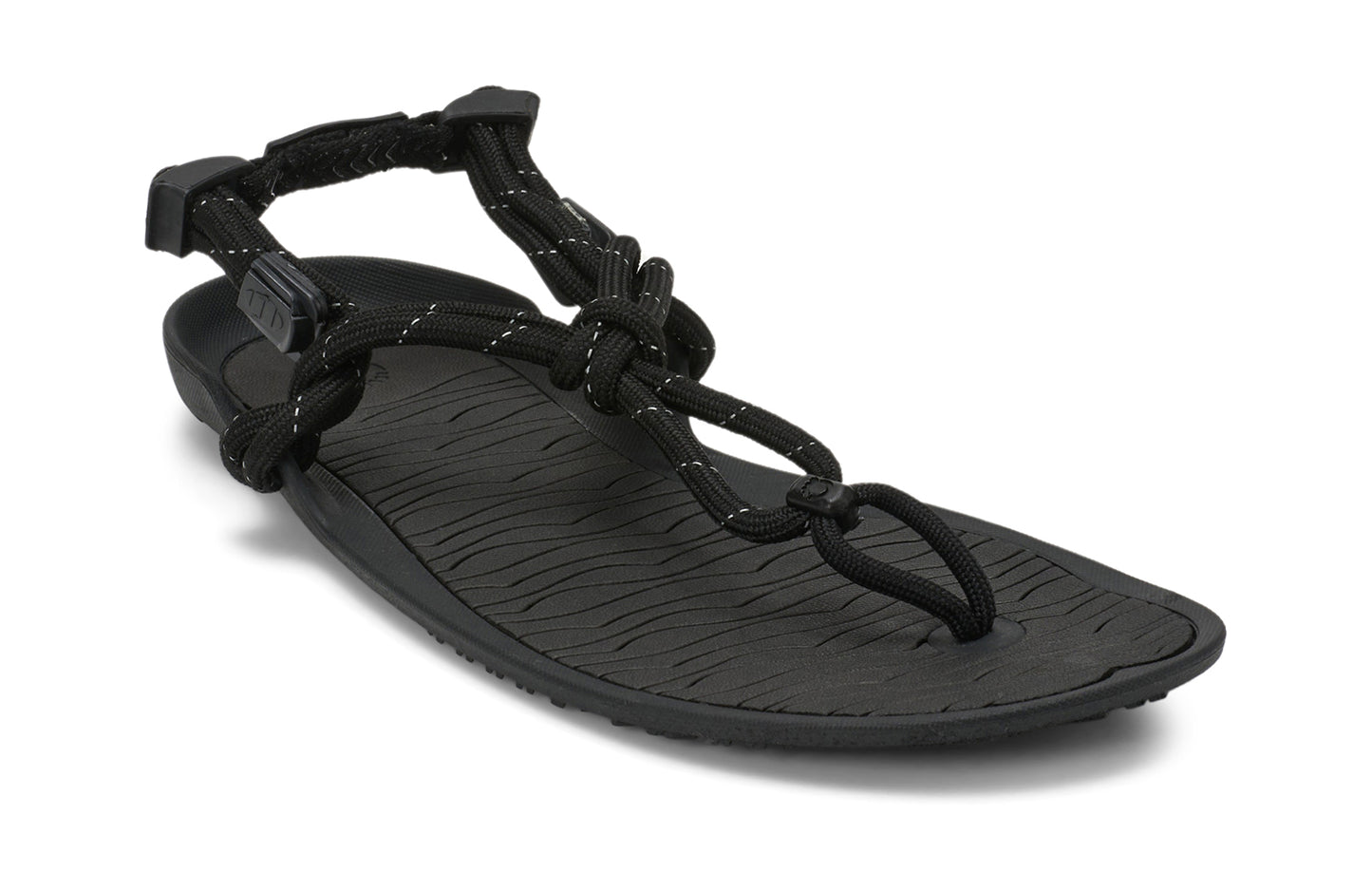 Xero Shoes Canada, specifically women’s barefoot shoes Canada. These minimalist shoes have flexible soles, wide toe boxes, and zero drop. Angled view of Xero Women's Aqua Cloud in Black. Versatile water sport and hiking sandal.