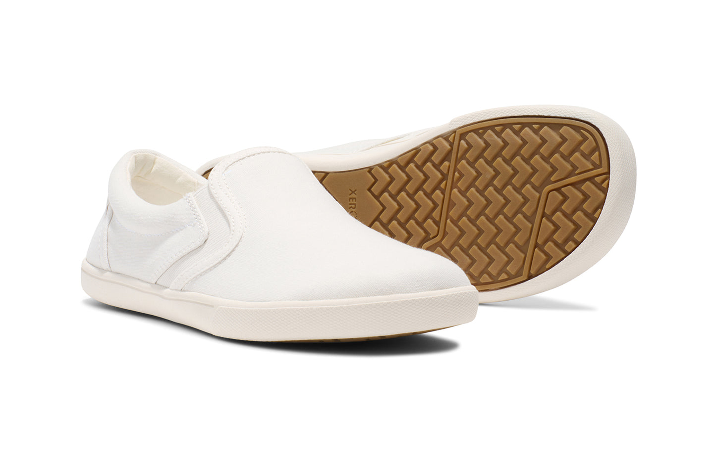 Xero Shoes Canada, specifically women’s barefoot shoes Canada. These minimalist shoes have flexible soles, wide toe boxes, and zero drop. Pair view of Xero Women's Dillon Canvas Slip-On in White. Slip-on sneaker.