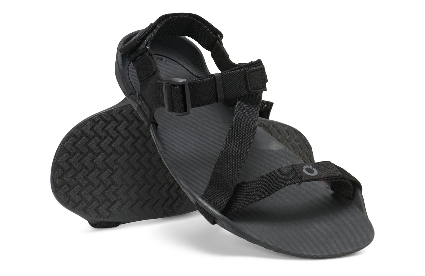 Xero Barefoot Shoes sold in Ontario, Canada. These minimalist shoes have flexible soles, wide toe boxes, and zero drop. Angled pair view of Xero Men's Z-Trek in Black, a lightweight packable sport sandal.