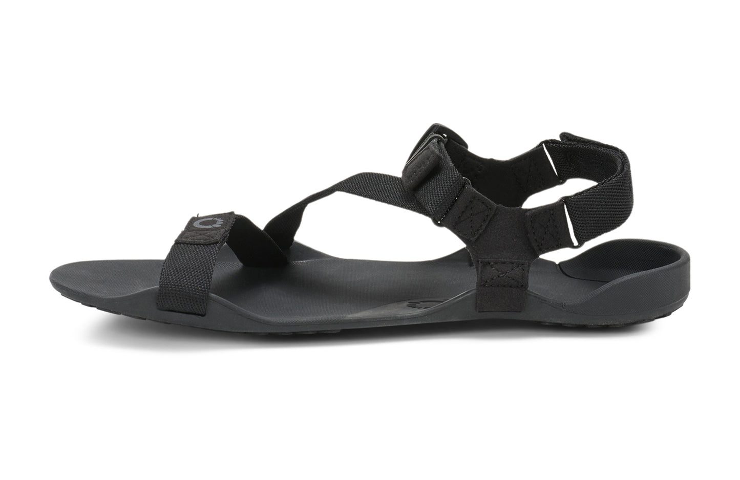 Xero Barefoot Shoes sold in Ontario, Canada. These minimalist shoes have flexible soles, wide toe boxes, and zero drop. Side view of Xero Men's Z-Trek in Black, a lightweight packable sport sandal.