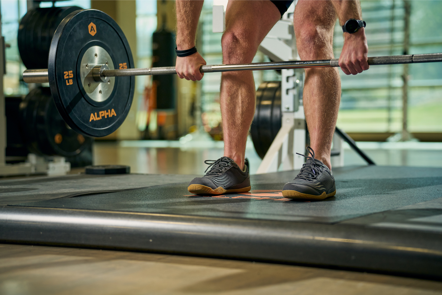 Xero shoes Canada, a barefoot running shoe Canada. Man lifting weight while wearing Xero 360 shoes.