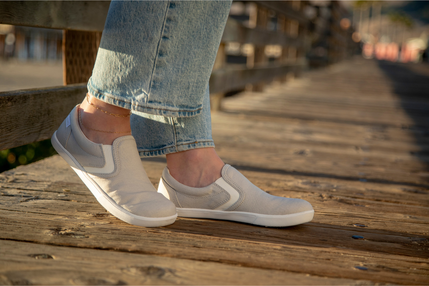 Xero Shoes Canada, specifically women’s barefoot shoes Canada. Woman wearing Dillon Canvas Slip-Ons with jeans on a dock