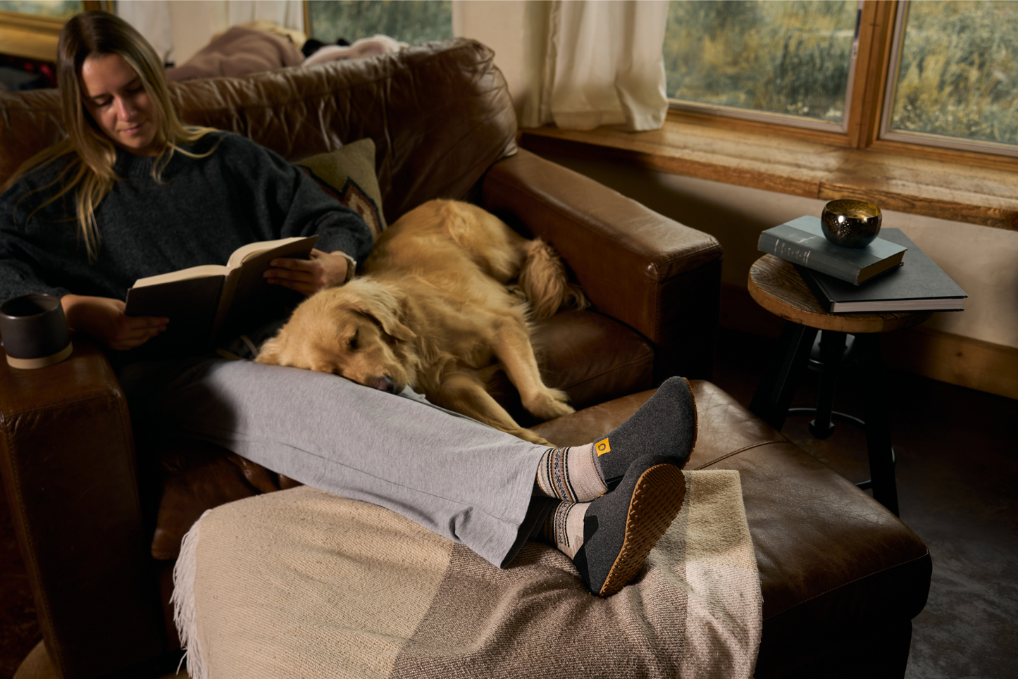 Xero Shoes Canada, specifically women’s barefoot shoes Canada. Woman wearing Pagosas on leather couch