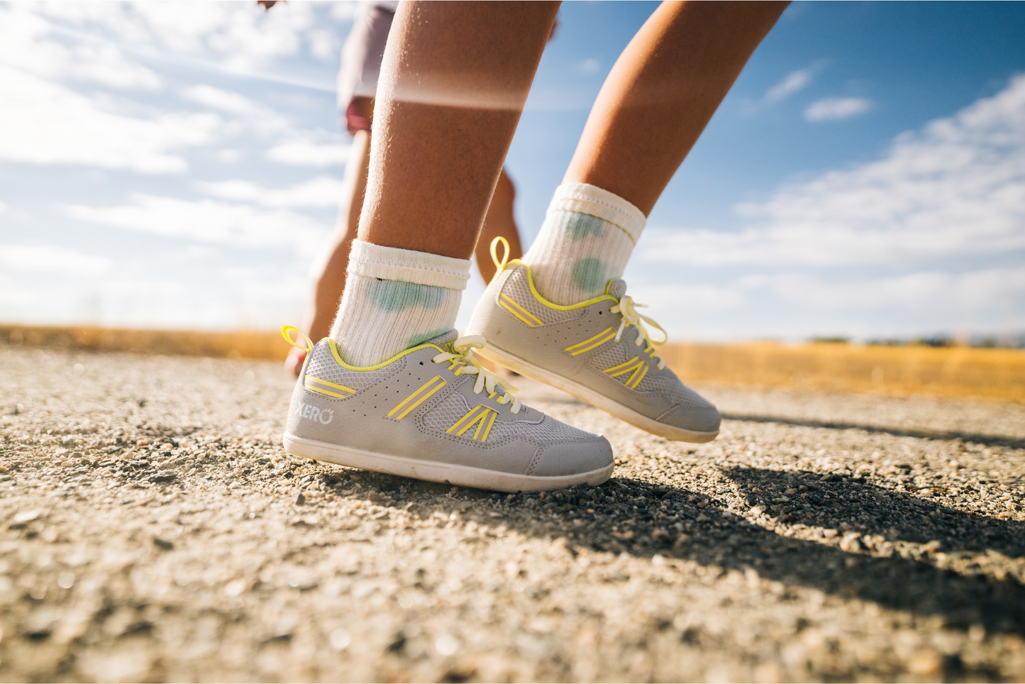 Xero Barefoot shoes for kids in Canada. Kid wearing shoes on gravel
