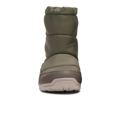 Green winter boot with a white sole on a white background.  Tru Stride Co brings Xero shoes to Canada