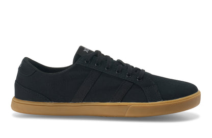 Xero Shoes Canada, specifically women’s barefoot shoes Canada. These minimalist shoes have flexible soles, wide toe boxes, and zero drop. Side view of Xero Women's Dillon Canvas in Black Gum, a classic sneaker.