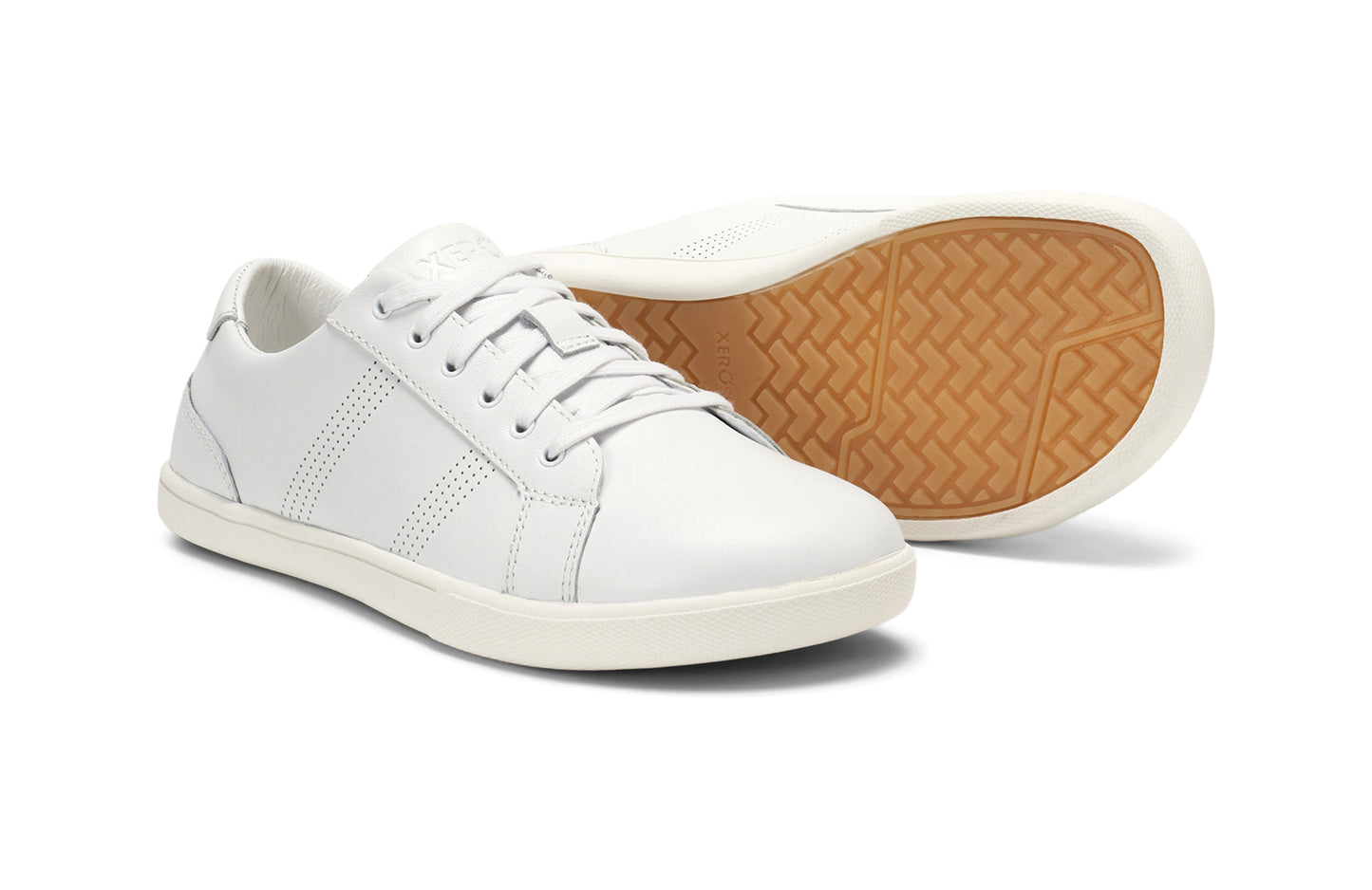 Xero Shoes Canada, specifically women’s barefoot shoes Canada. These minimalist shoes have flexible soles, wide toe boxes, and zero drop. Pair view of Women's Dillon Leather in White. A classic leather sneaker. 