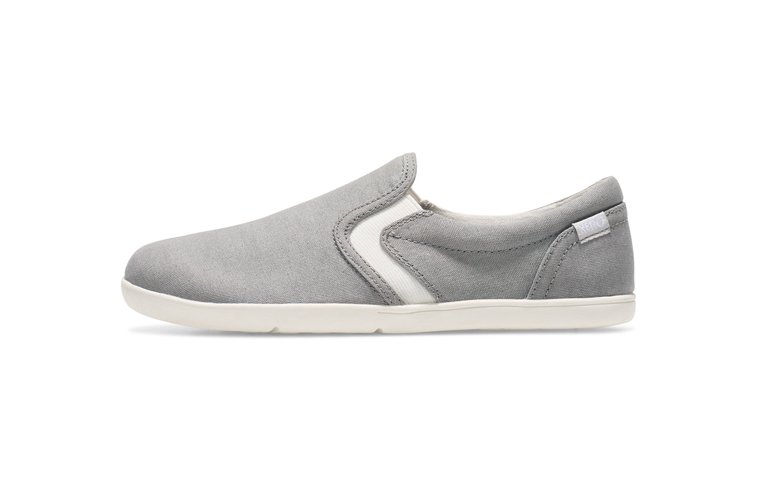 Xero Kid's Barefoot Shoes sold in Ontario, Canada. These minimalist shoes have flexible soles, wide toe boxes, and zero drop. Side view of Xero Youth Dillon Canvas Slip-On in Alloy. 