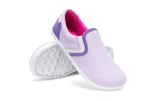 Xero Kid's Barefoot Shoes sold in Ontario, Canada. These minimalist shoes have flexible soles, wide toe boxes, and zero drop. Angled pair view of Xero Youth Dillon Canvas Slip-On in Orchid Petal. 