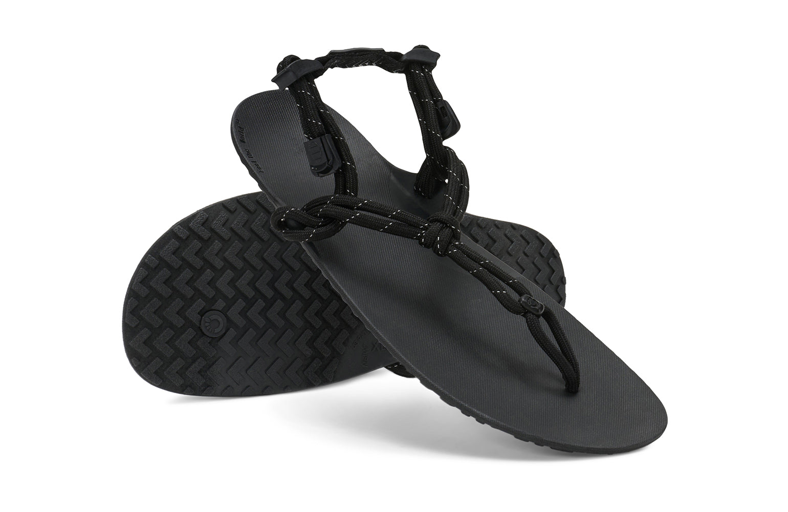 Xero Shoes Canada, specifically women’s barefoot shoes Canada. These minimalist shoes have flexible soles, wide toe boxes, and zero drop. Angled pair view of Xero Women's Genesis in Black. Lightweight, packable, travel-friendly sandal.  