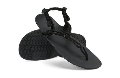 Xero Shoes Canada, specifically women’s barefoot shoes Canada. These minimalist shoes have flexible soles, wide toe boxes, and zero drop. Angled pair view of Xero Women's Genesis in Black. Lightweight, packable, travel-friendly sandal.  