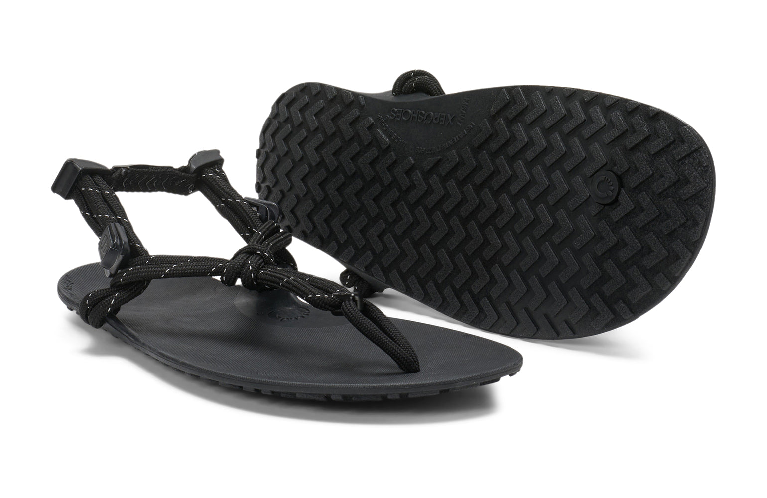 Xero Shoes Canada, specifically women’s barefoot shoes Canada. These minimalist shoes have flexible soles, wide toe boxes, and zero drop. Pair view of Xero Women's Genesis in Black. Lightweight, packable, travel-friendly sandal.  
