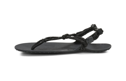 Xero Shoes Canada, specifically women’s barefoot shoes Canada. These minimalist shoes have flexible soles, wide toe boxes, and zero drop. Medial side view of Xero Women's Genesis in Black. Lightweight, packable, travel-friendly sandal.  