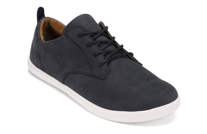 Xero Shoes Canada, specifically men’s barefoot shoes Canada. These minimalist shoes have flexible soles, wide toe boxes, and zero drop. Angled view of Xero Men's Glenn in Black/White. Dress casual leather shoe. 