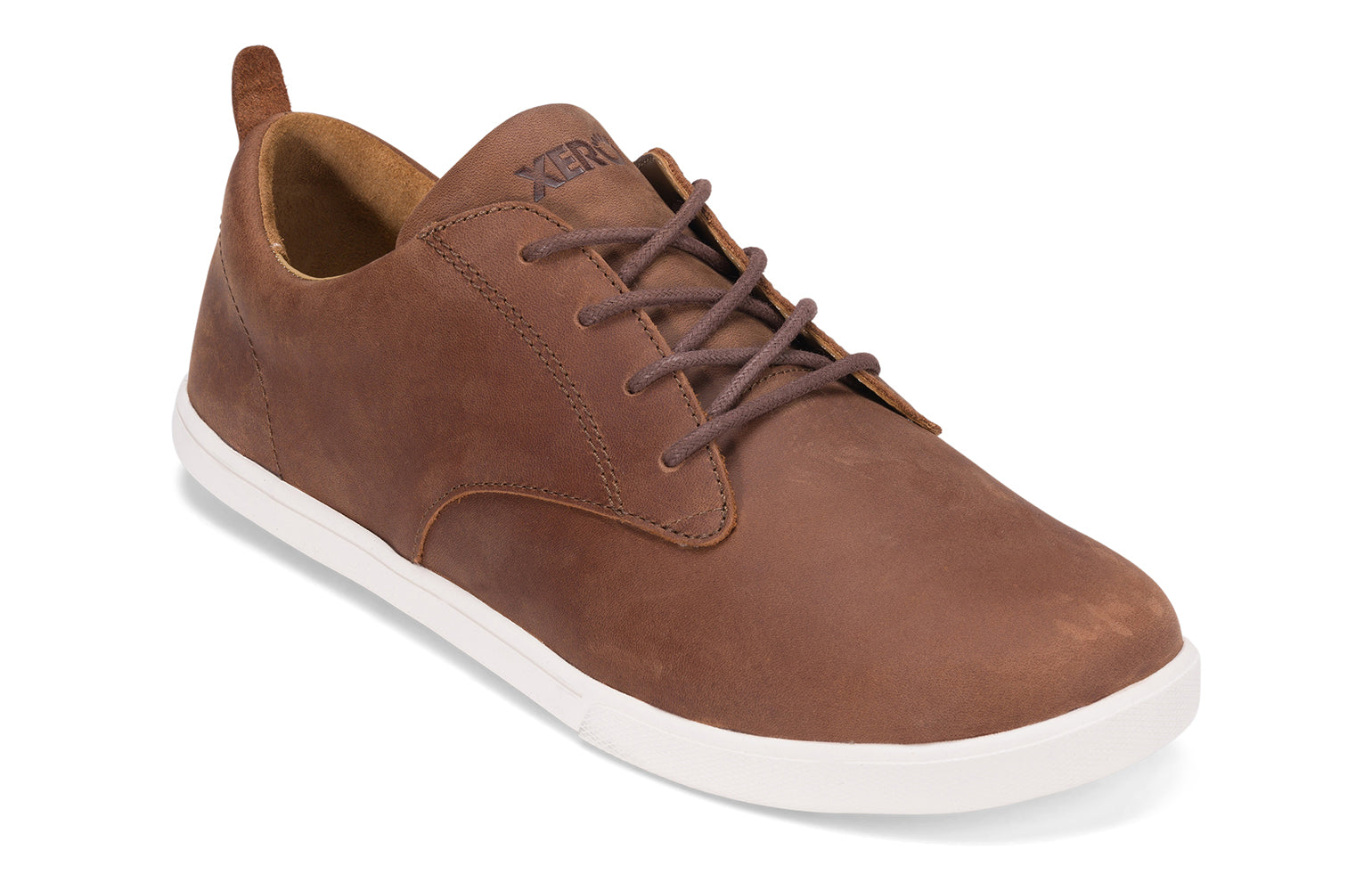 Xero Shoes Canada, specifically men’s barefoot shoes Canada. These minimalist shoes have flexible soles, wide toe boxes, and zero drop. Angled view of Xero Men's Glenn in Brown. Dress casual leather shoe. 