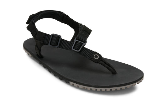 Xero Shoes Canada, specifically men’s barefoot shoes Canada. These minimalist shoes have flexible soles, wide toe boxes, and zero drop. Angled view of Men's H-Trail in Black. A huarache-style hiking sandal.