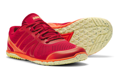 Red and orange athletic shoe with a white sole on a white background.  Tru Stride Co brings Xero Shoes to Canada
