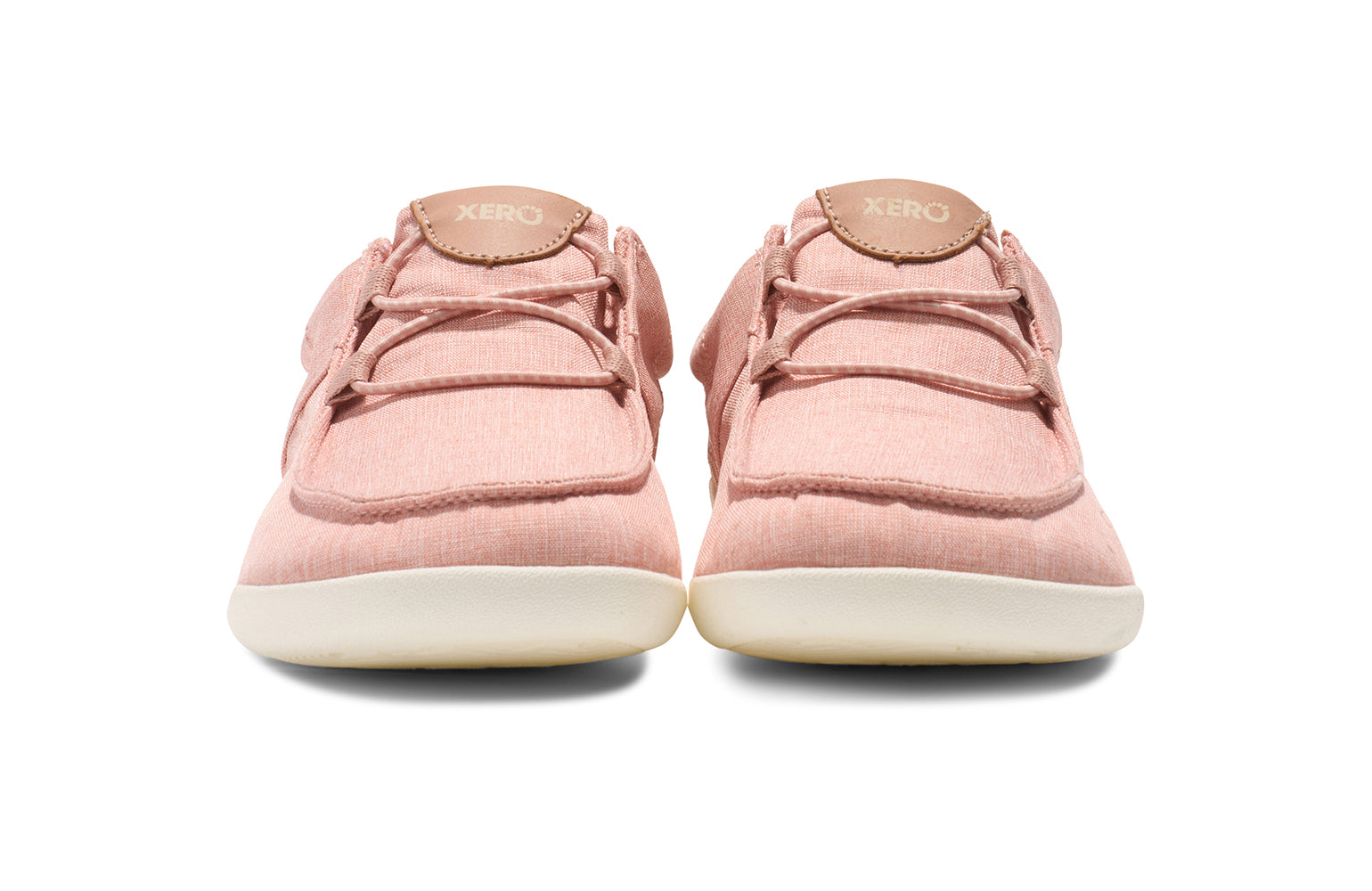 Xero Shoes Canada, specifically women’s barefoot shoes Canada. These minimalist shoes have flexible soles, wide toe boxes, and zero drop. Front view of Xero Women's Kona in Pink Sand. Moccasin inspired casual shoe. 