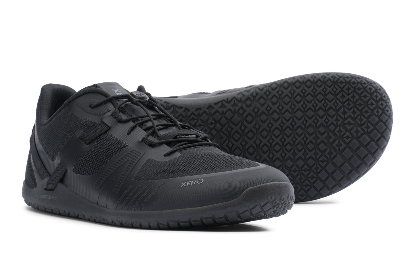 Black athletic shoes with textured sole on a white background. Tru Stride Co brings Xero Shoes to Canada