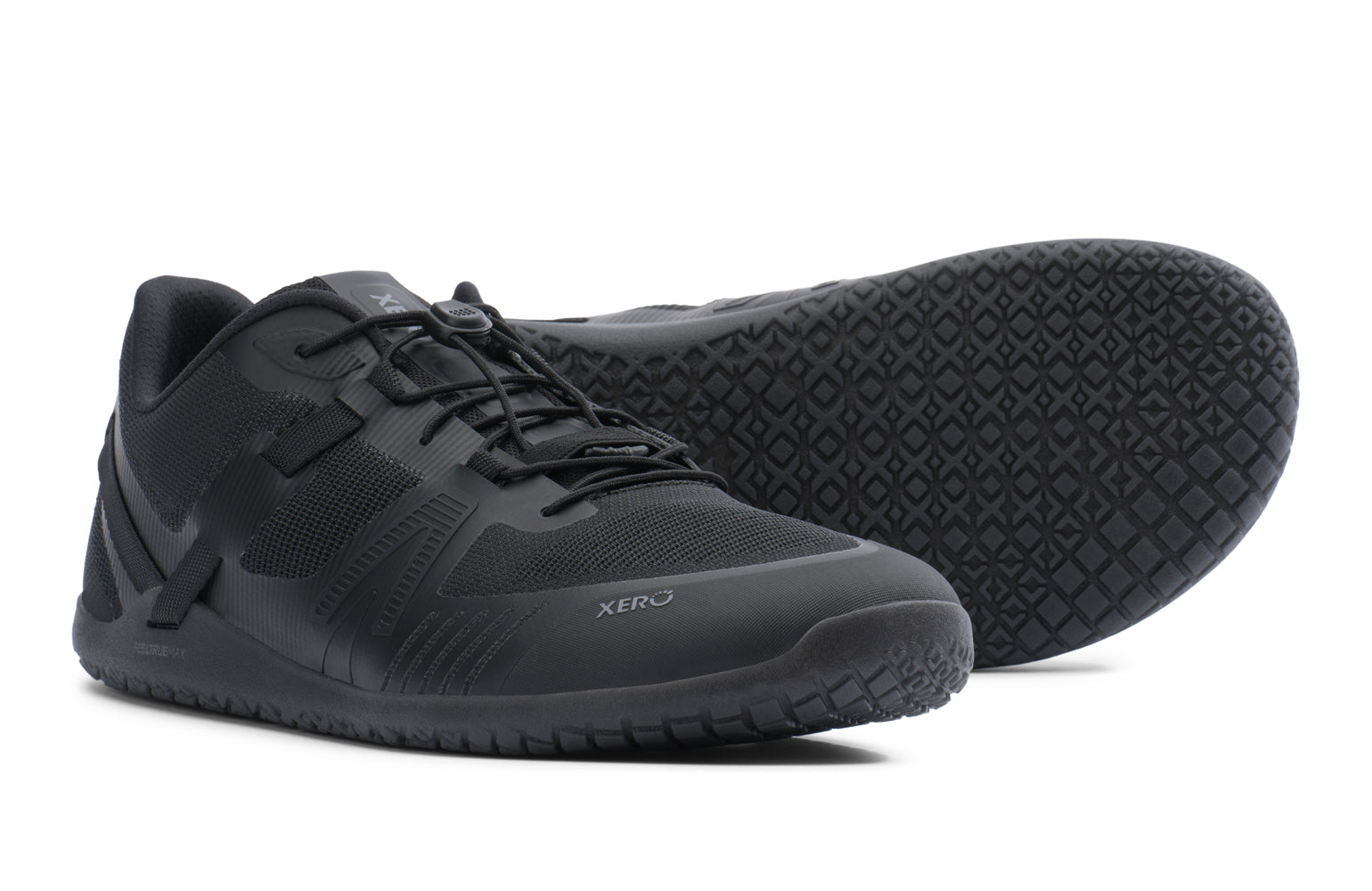 Black athletic shoes with textured sole on a white background. Tru Stride Co brings Xero Shoes to Canada